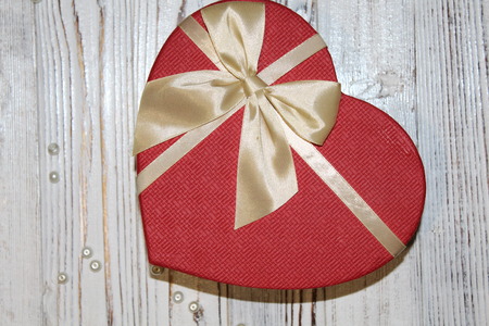 Red heart on a white wooden old tableの写真素材
