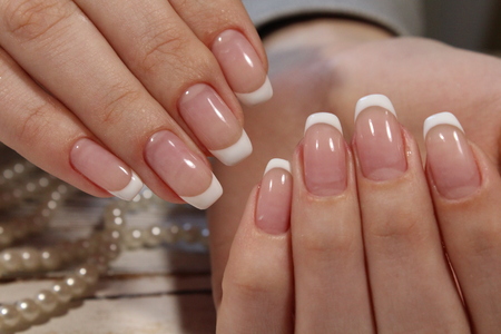 fashionable french manicure on a beautiful textural backgroundの写真素材