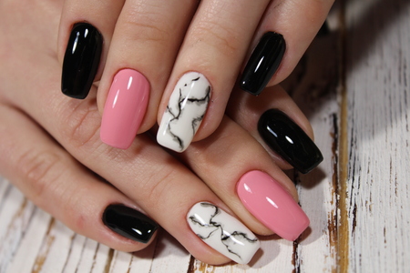 fashionable pink manicure gel varnish with marble designの写真素材