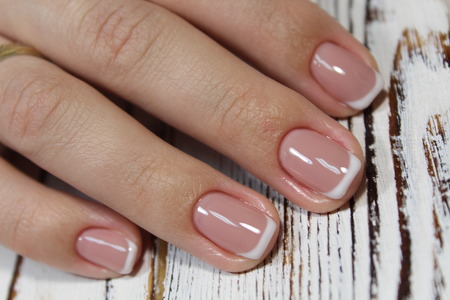 fashionable french manicure on beautiful female handsの写真素材
