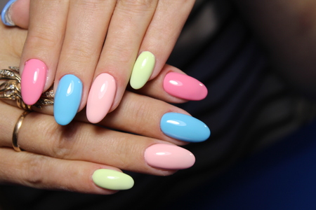 fashionable multicolored manicure on white textural backgroundの写真素材