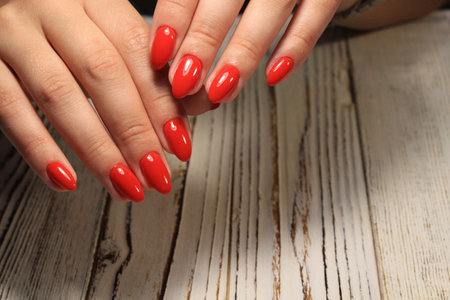 fashionable red manicure on long beautiful nailsの写真素材