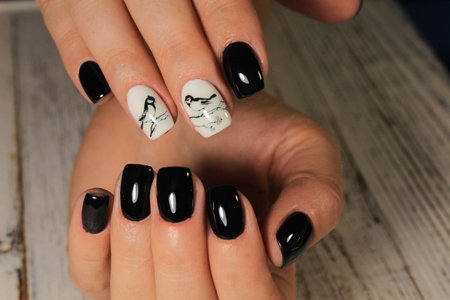 stylish black nails on beautiful female hands