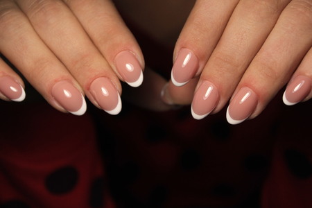 beautiful French manicure on a trendy texture backgroundの写真素材