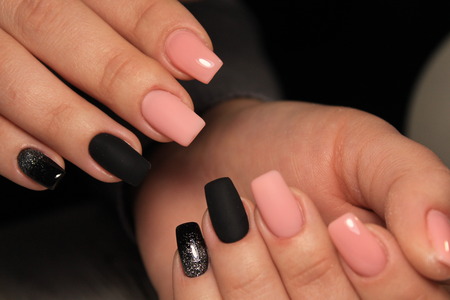 Stylish pink manicure on long beautiful handsの写真素材