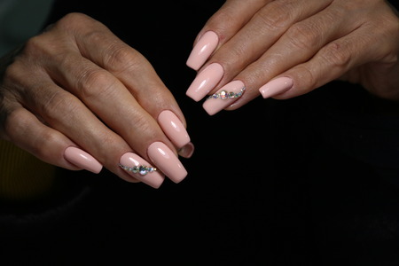 manicure with long nails on a trendy texture backgroundの写真素材