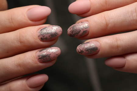 beautiful gel lacquer manicure on a textured trendy backgroundの写真素材