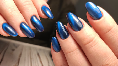 Beautiful nail design on female hands on background. 2019