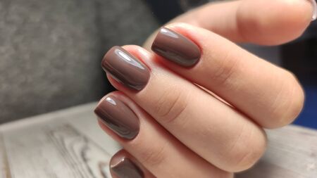 fashionable beige manicure with a silver pattern designの写真素材