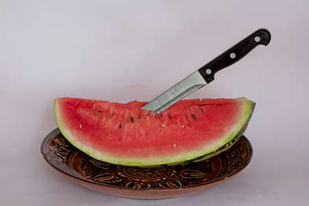 Watermelon with a knife in Uzbek large plateの写真素材