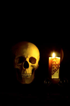 mystical skull in a dark space in the candlelightの写真素材