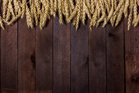 arrangement of wheat ears on the table for design with copy spaceの写真素材