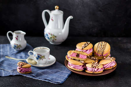Evening tea with sweets, a festive atmosphere on a dark background.の写真素材