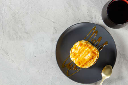 Fried curd pancakes are poured with boiled tender caramel. Delicious healthy food. flat top view, copy space, on a light backgroundの写真素材