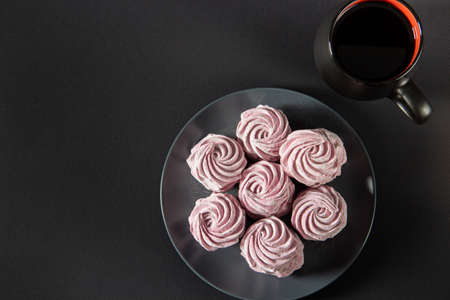 Pattern sweet marshmallows, candies on a black background, flat top view. Isolated minimal concept above decoration, view of pink marshmallow, food backgroundの素材 [FY310181012119]