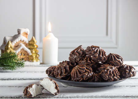 Marshmallow in chocolate with burning candles.の写真素材