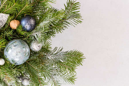 Fir branches, thuja branch, pine cones, and christmas balls on white background.の写真素材