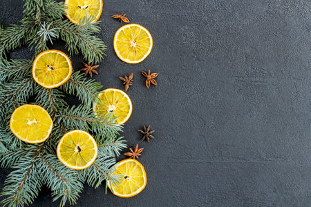 postcard, frame, banner on black concrete from above with Christmas decorations, oranges New Year. branch of blue spruce. flat lay.の写真素材