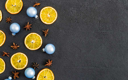 postcard, frame, banner on black concrete from above with Christmas decorations, oranges New Year. flat lay.の写真素材