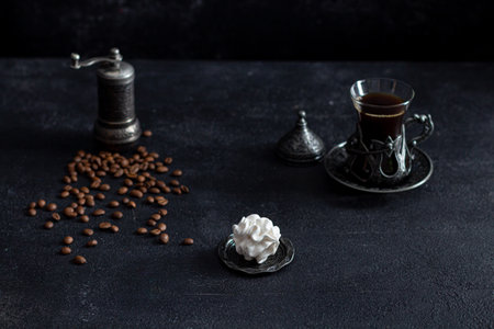 zepfir on a dark background in a plate in the background - a cup of coffee.の写真素材