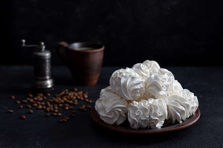 zepfir on a dark background in a plate in the background - a cup of coffee.の写真素材