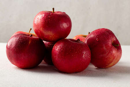 Fresh ripe red apples on a gray background, side viewの写真素材