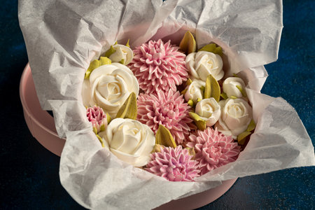 Marshmallow bouquet of flowers in a gift box on a blue background, festive mood, Valentine's Day, International Women's Dayの写真素材