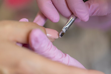 Nails manicure detail with file or brush item. Woman beautiful nail care process.の写真素材