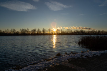 The beauty of the autumn Lake at sunrise with the rays of the sunの写真素材