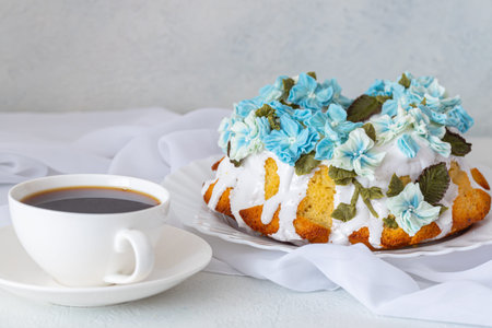 A beautiful cake decorated with marshmallows and a cup of coffee