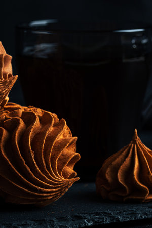 Coffee Zephyr features rich chocolate swirls and delicate meringue on a dark slate background, creating an inviting atmosphere for dessert lovers with copy spaceの写真素材