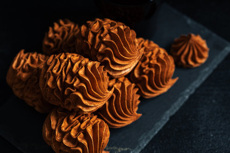 Coffee Zephyr dessert displayed on dark slate, highlighting its unique shape and texture, creating an inviting atmosphere for food enthusiasts and culinary artistsの写真素材
