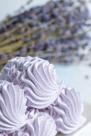 Homemade lavender zephyr displayed on a light background, highlighting its delicate texture and soft hues, creating an inviting and serene atmosphere for dessert loversの写真素材