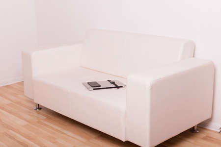 White leather sofa stands in the office. High quality photoの写真素材
