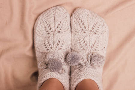 Handmade knitted socks on the legs. High quality photoの写真素材