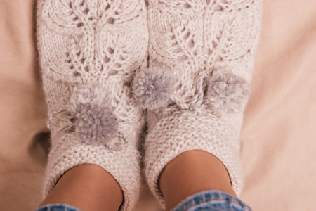 Handmade knitted socks on the legs. High quality photo