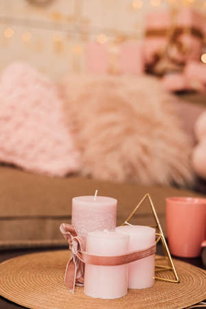 Lights and cups stand on the coffee table near the sofa.の写真素材
