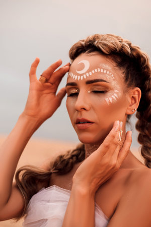 Portrait of a beautiful girl with creative makeup and boho hairstyle