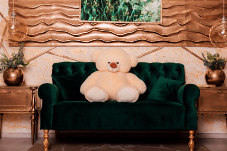 A teddy bear on a green sofa. Modern interiorの写真素材