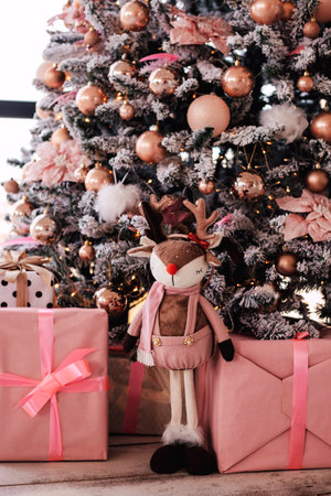 Under the Christmas tree pink boxes with gifts, soft toy deer. New Yearの写真素材