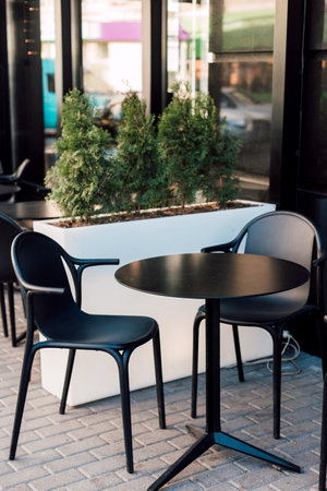 Black chairs and a table in a summer cafe outside. Lunch, restの写真素材