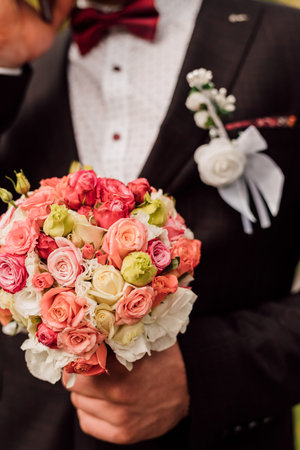 Wedding bouquet in the grooms hand. Wedding Day, Flowers