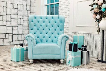Gifts in boxes and a blue chair in the New Years interiorの写真素材