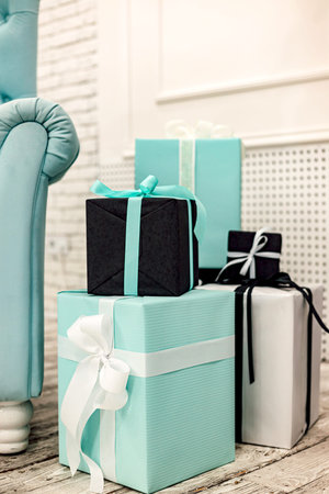 Blue boxes and black boxes with gifts in the interior. Boxing Day