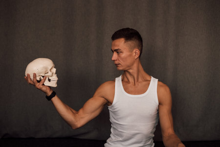 A white skull in the hands of a man. Anatomyの写真素材