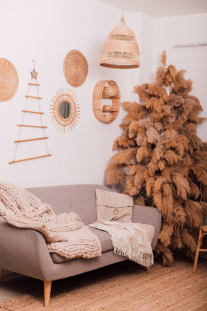 Stylish modern sofa in the home interior. Christmas tree made of dried flowersの写真素材