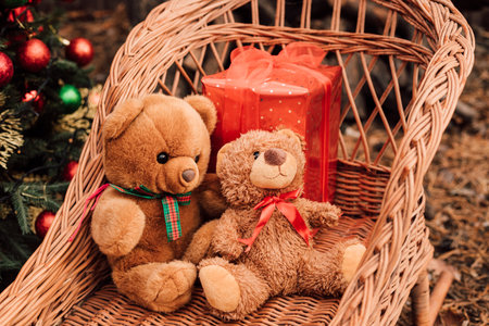 Teddy bears in wooden sleds. Red box with Christmas giftの写真素材