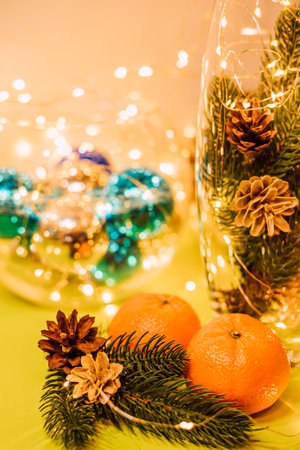 New Years composition with a vase, tangerines, spruce cones. Christmas moodの写真素材