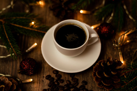 Coffee break on Christmas evening. A cup of espresso coffee on the table near the Christmas tree. High quality photoの写真素材