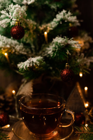 Cup of tea with croissant near Christmas tree. New Year's Eve at home with family. High quality photoの写真素材